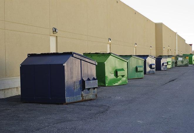 a row of yellow and blue dumpsters at a construction site in Chatsworth CA